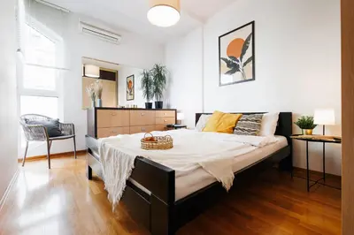 a bedroom with a large bed with a basket on it at Big Company 3min to Republic Square Renovated in Belgrade