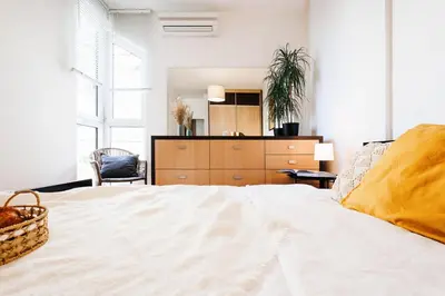 a bedroom with a bed with a dresser and a mirror at Big Company 3min to Republic Square Renovated in Belgrade