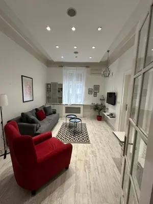 a living room with a red couch and a table at Sofi1 in Belgrade