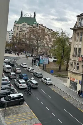 a busy city street with cars parked in front of buildings at Sofi1 in Belgrade