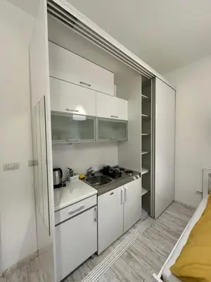 a kitchen with white cabinets and a sink at Sofi 2 in Belgrade