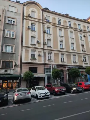 a large building with cars parked in front of it at Sofi 2 in Belgrade