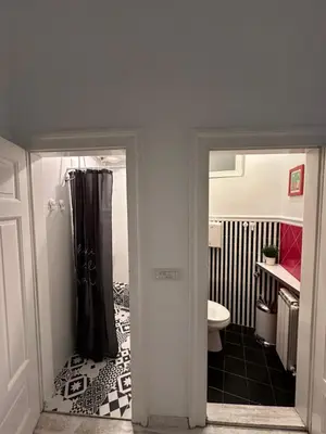 a bathroom with a shower curtain and a toilet at Sofi 2 in Belgrade