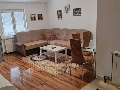 a living room with a couch and a table at Stan na dan BALANS in Ledine