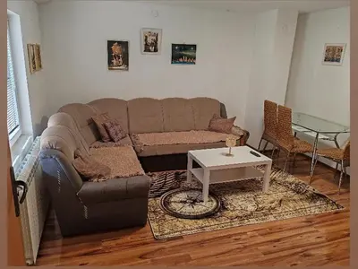 a living room with a couch and a table at Stan na dan BALANS in Ledine