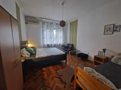a bedroom with two beds and a window at Central Station Private Rooms in Belgrade