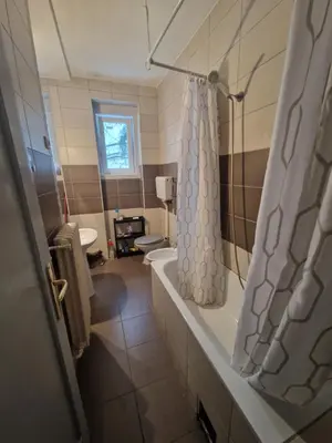 a bathroom with a tub and a shower curtain at Central Station Private Rooms in Belgrade