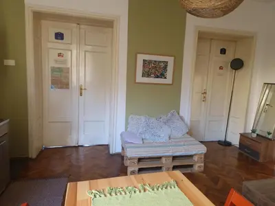 a living room with a couch and a table at Central Station Private Rooms in Belgrade