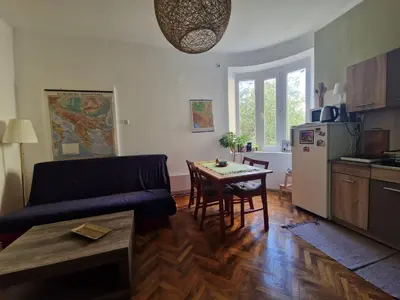 a living room with a couch and a table at Central Station Private Rooms in Belgrade
