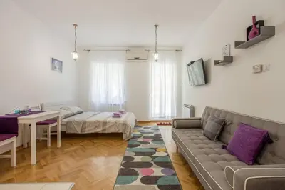a living room with a couch and a table at Studio apartment Duda in Karaburma