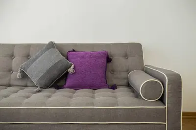 a couch with two pillows and a purple pillow at Studio apartment Duda in Karaburma