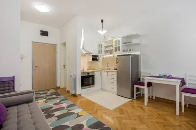 a kitchen with a refrigerator and a table in a room at Studio apartment Duda in Karaburma