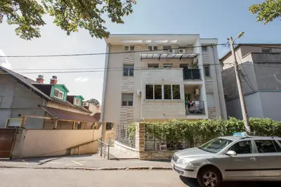 a car parked in front of a house at Studio apartment Duda in Karaburma