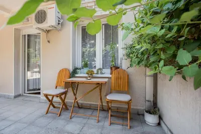 a table and two chairs sitting next to a window at Studio apartment Duda in Karaburma