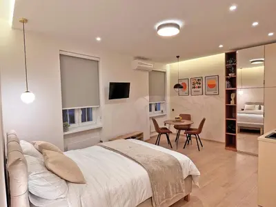 a bedroom with a bed and a table and chairs at Terazije Center Apartments in Belgrade