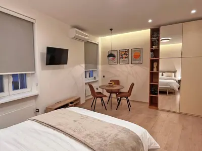 a bedroom with a bed and a table and chairs at Terazije Center Apartments in Belgrade