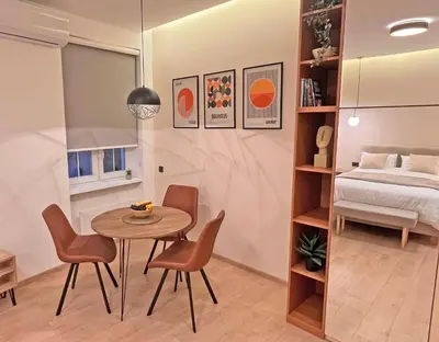 a small room with a table and chairs and a bed at Terazije Center Apartments in Belgrade