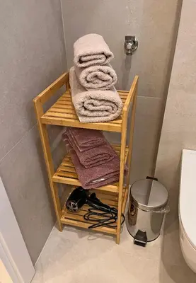 a wooden shelf with towels on it in a bathroom at Terazije Center Apartments in Belgrade