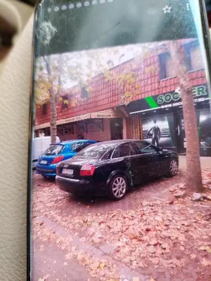 a picture of a black car parked in front of a building at Apartman Birboni Pul ZEMUN in Tošin Bunar