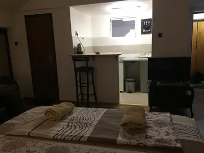 a bedroom with a bed with two towels on it at Apartman Birboni Pul ZEMUN in Tošin Bunar
