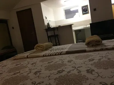 a bedroom with two beds with towels on them at Apartman Birboni Pul ZEMUN in Tošin Bunar