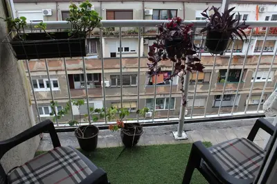 a balcony with potted plants and a building at Belgrade Waterfront studio in Sajmište