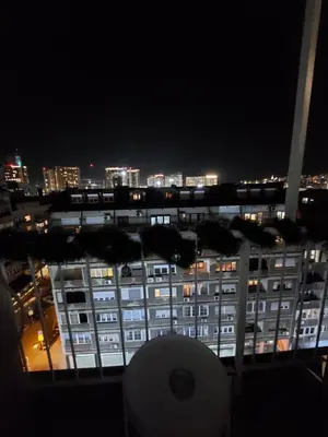 a view of a large building at night at Belgrade Waterfront studio in Sajmište