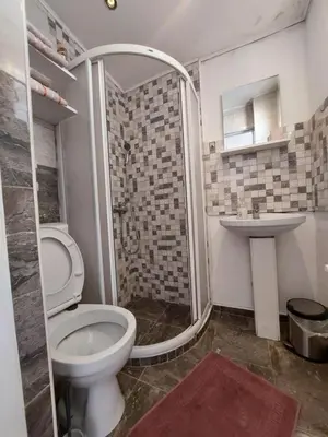 a bathroom with a shower and a toilet and a sink at Belgrade Waterfront studio in Sajmište