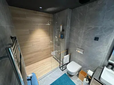 a bathroom with a shower with a toilet and a sink at Belgrade Waterfront Luxury Apartment in Belgrade