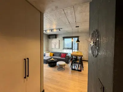 a living room with a couch and a table at Belgrade Waterfront Luxury Apartment in Belgrade