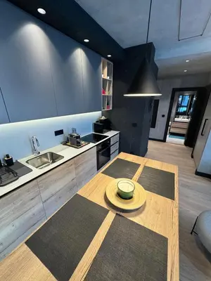 a kitchen with a wooden table with a plate on it at Belgrade Waterfront Luxury Apartment in Belgrade