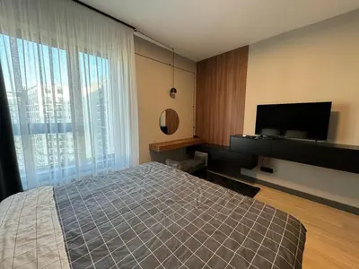 a bedroom with a bed and a flat screen tv at Belgrade Waterfront Luxury Apartment in Belgrade