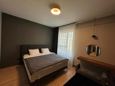 a bedroom with a bed with a mirror and a window at Belgrade Waterfront Luxury Apartment in Belgrade