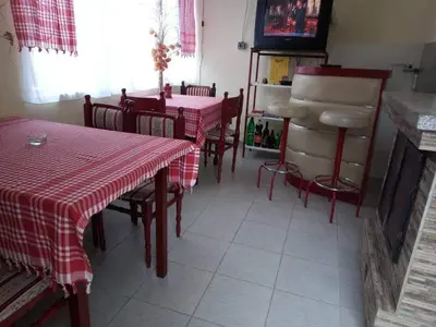 a restaurant with two tables and chairs with red and white table cloth at Apartmani Pavlov in Arandjelovac