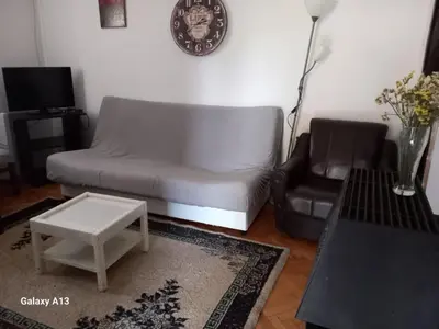 a living room with a couch and a chair at Apartmani Pavlov in Arandjelovac