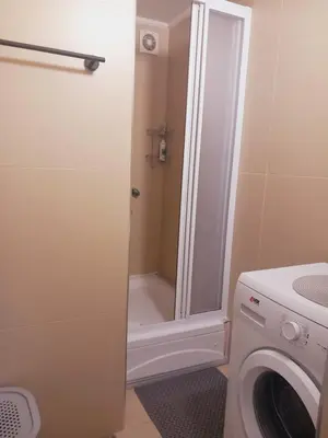 a bathroom with a washing machine and a shower at LIBERO 78 in Vračar (historical)