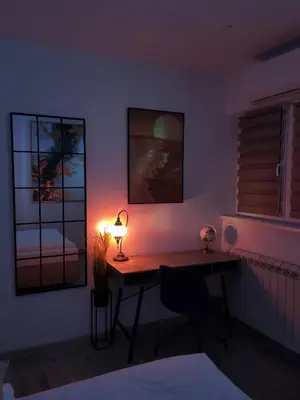 a room with a desk with a lamp on it at Penthouse Palace in Belgrade