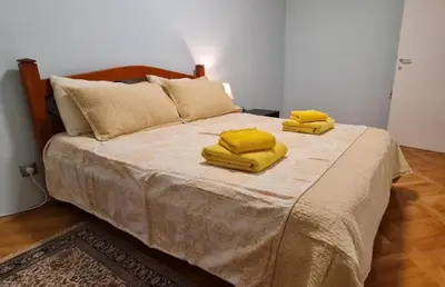 a bedroom with a bed with yellow towels on it at Best to rest B62 in Belgrade