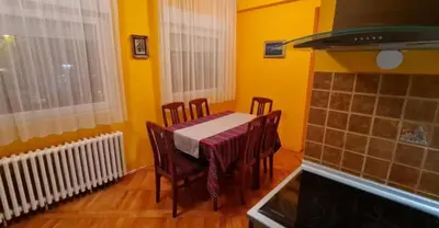 a dining room with a table and chairs and yellow walls at Best to rest B62 in Belgrade