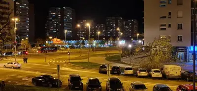 a parking lot with cars parked in a city at night at Best to rest B62 in Belgrade
