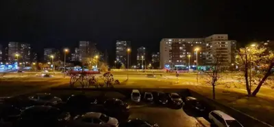 a city at night with cars parked in a parking lot at Best to rest B62 in Belgrade