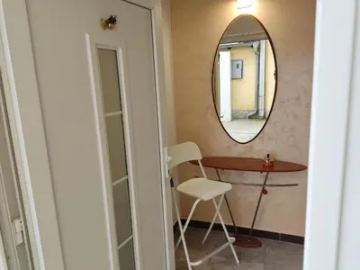 a mirror in a room with a table and a chair at Romansa in Dušanovac (historical)