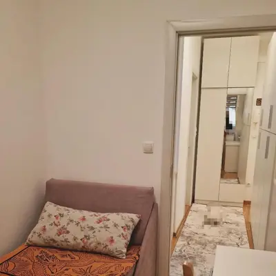 a couch in a room with a pillow on it at Laki 15 in Kalugjerica