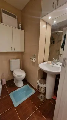a bathroom with a toilet and a sink and a mirror at Laki 15 in Kalugjerica