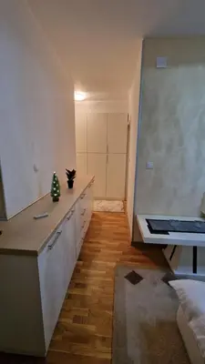 a kitchen with white cabinets and a counter top at Laki 15 in Kalugjerica