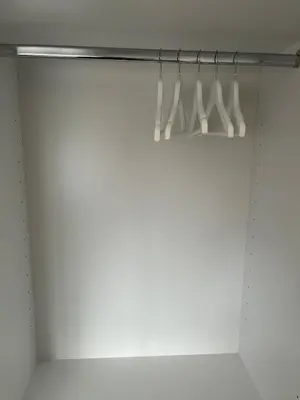 a closet with white utensils on a rack at Apartman Stevan in Pančevo