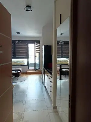 a room with a hallway with a television and a room with at Viva apartment in condominium in Voždovac