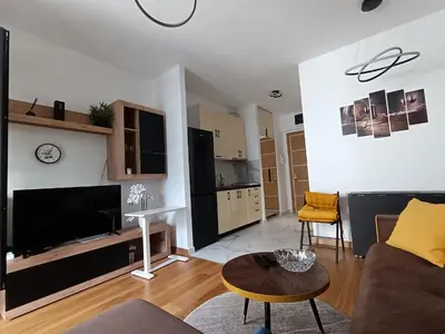 a living room with a couch and a table at Viva apartment in condominium in Voždovac