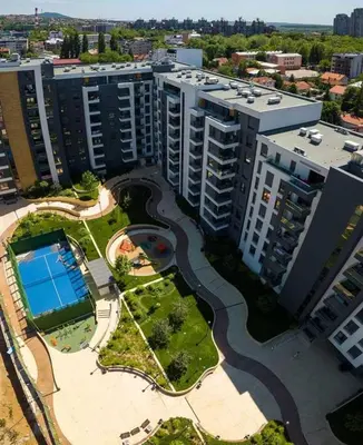 an aerial view of a large building with a pool at Viva apartment in condominium in Voždovac