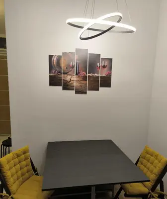 a dining room with a table and a chandelier at Viva apartment in condominium in Voždovac
